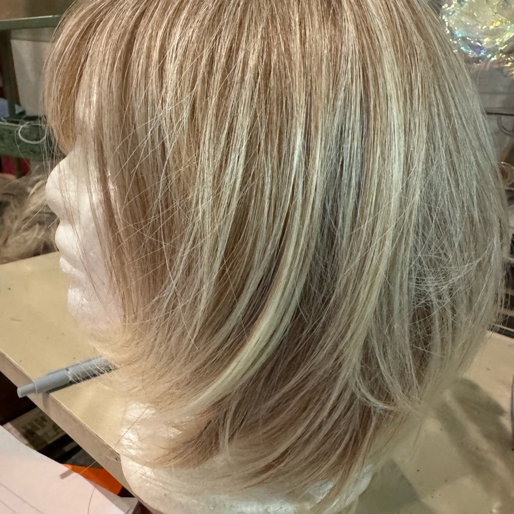 Light blonde, highlighted, chin length wig with bangs. Excellent condition.